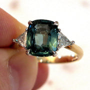 4 Carat Teal Sapphire 3 Stone Engagement Ring with Trillion Diamonds in Mixed Metal