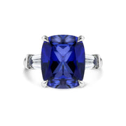 Deep blue sapphire engagement ring with baguette diamonds. DANA WALDEN BRIDAL.