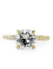 Diamond solitaire engagement ring in yellow gold with accent diamonds underneath stone and in band