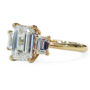 Delicate emerald cut three stone engagement ring in yellow gold custom made in nyc - emma 