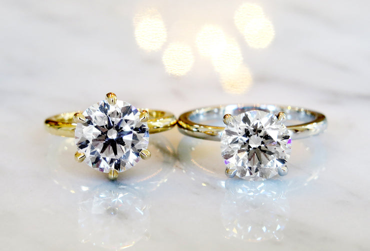 Custom diamond solitaires with delicate bands in yellow gold & platinum
