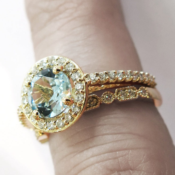 Aquamarine Halo Engagement Ring in Yellow Gold With Diamond Accents On Hand by Dana Walden Bridal, NYC