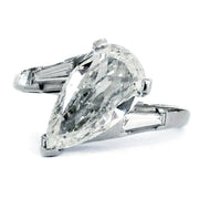 A pear-shaped diamond engagement ring set in white gold or platinum. Dana Walden Bridal in New York City.