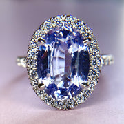 Purple sapphire and platinum engagement ring with ethical diamond halo. DANA WALDEN NYC.