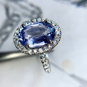 Purple sapphire and platinum engagement ring with ethical diamond halo. DANA WALDEN NYC.
