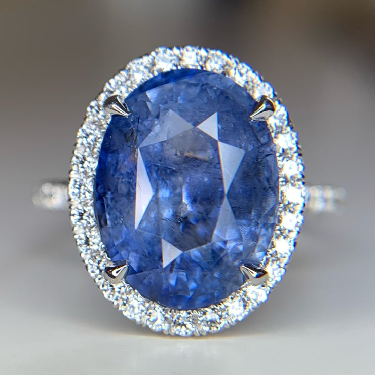 Vivienne blue-gray sapphire oval engagement ring with white diamond halo and micro pave band. DANA WALDEN BRIDAL NYC.