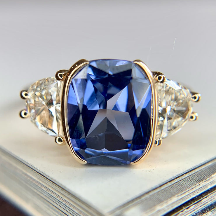 Blue sapphire engagement ring set in yellow gold with lunette diamond accents - Dana Walden Bridal NYC