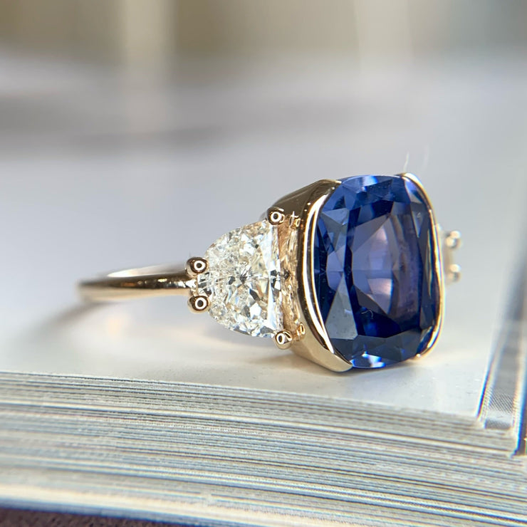 Blue sapphire engagement ring set in yellow gold with lunette diamond accents - Dana Walden Bridal NYC