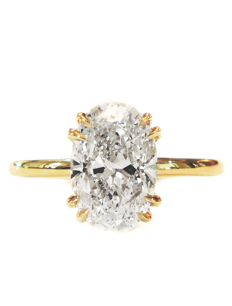 Oval diamond engagement ring in yellow gold, solitaire setting, double prongs & thin band
