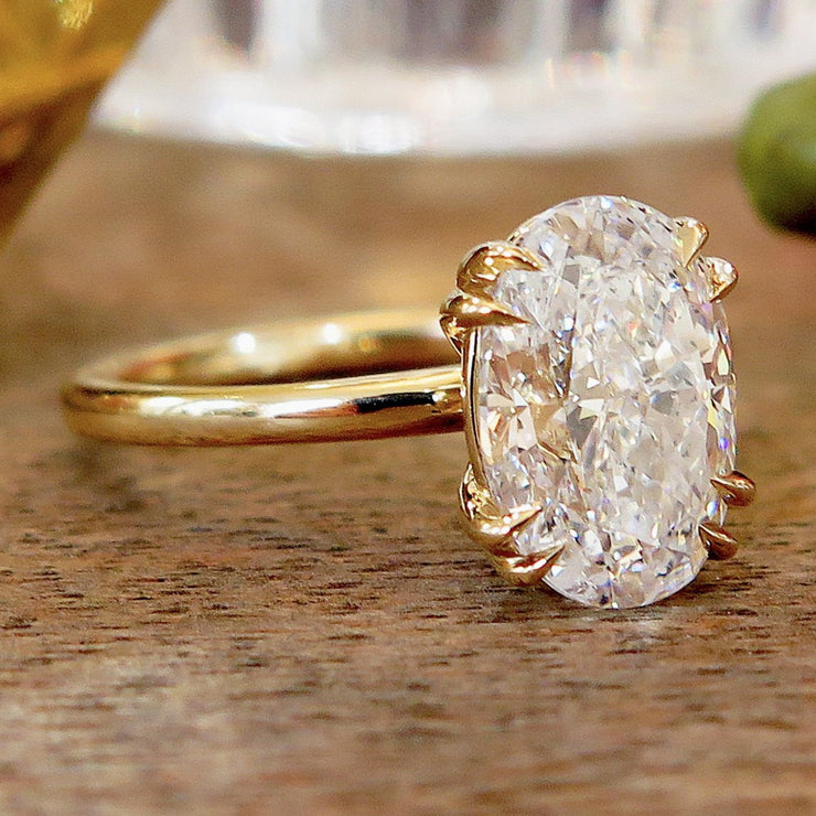 Oval lab diamond solitaire engagement ring set in yellow gold. Dana Walden NYC