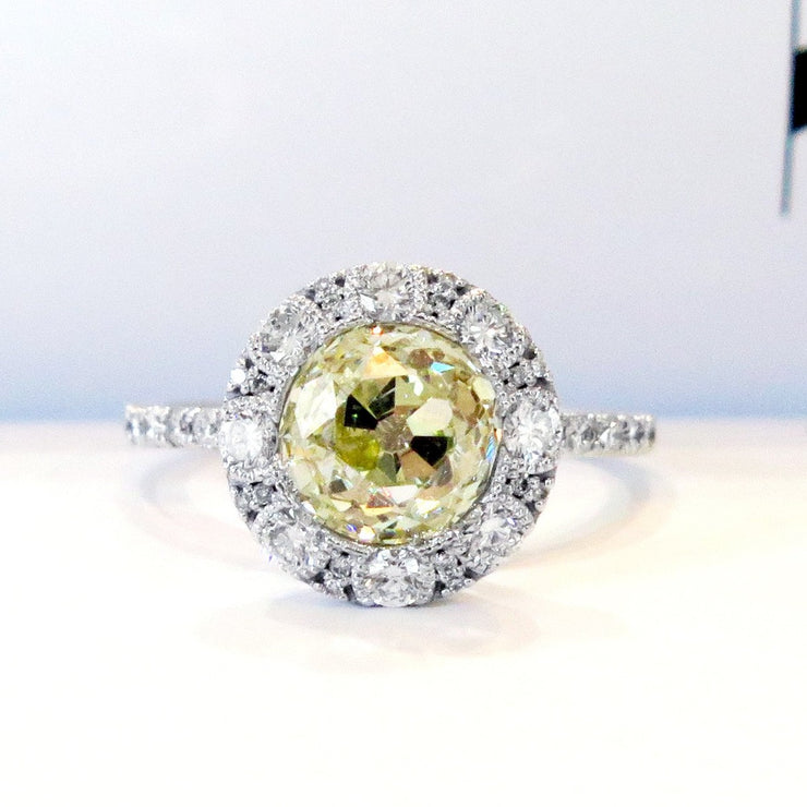 Old mine yellow diamond  with white diamond halo. DANA WALDEN BRIDAL NYC.