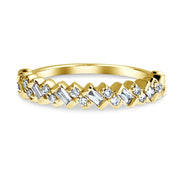 Wedding ring with diagonally set baguette diamonds and round diamonds set in yellow gold. DANA WALDEN BRIDAL.