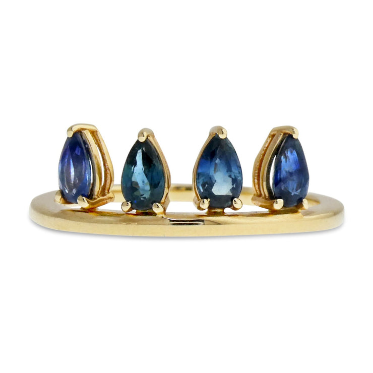Larkyn is a ring with four pear-shaped blue sapphires set vertically along a gold band. Handmade by Dana Walden Jewelry in NYC USA.