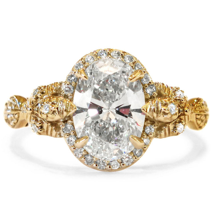 Yellow gold version of the Maiya oval diamond halo engagement ring by Dana Walden.