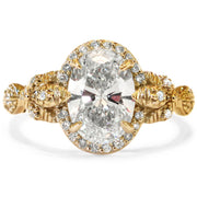 Yellow gold version of the Maiya oval diamond halo engagement ring by Dana Walden.