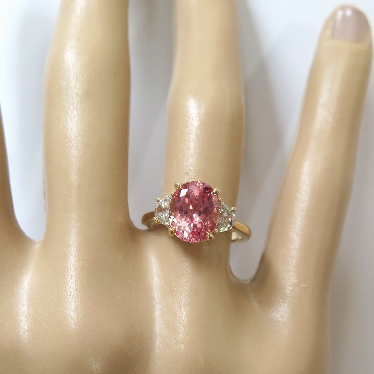Unique Peach Sapphire Engagement Ring on Hand with 3.76 carat Padparadscha Sapphire in Yellow Gold and Half Moon Diamonds for the Alternative Nontraditional Bride