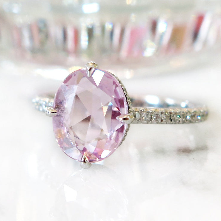 Custom peach sapphire engagement ring with diamond accents and thin band in white gold