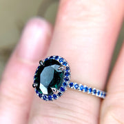 Gothic, handmade engagement ring with teal and blue sapphires set in white gold. Dana Walden Jewelry NYC.