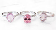 Peach and pink sapphire engagement rings with thin diamond bands in white gold or platinum