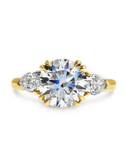 Three stone conflict-free diamond engagement ring set in yellow gold.