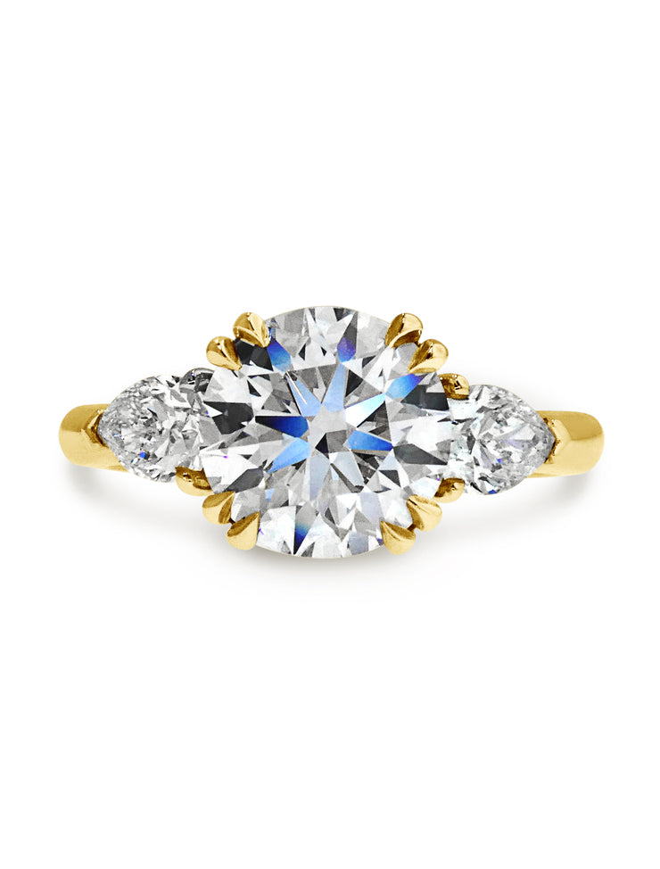 Three stone conflict-free diamond engagement ring set in yellow gold.