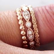 Suite of three stackable rose gold rings by DANA WALDEN.