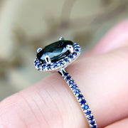 Side view of Gothic, handmade engagement ring with teal and blue sapphires set in white gold. Dana Walden Jewelry NYC.