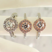 A trio of rose gold and platinum halo engagement rings 