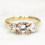 Unique handmade three stone diamond engagement ring set in yellow gold.