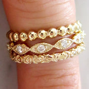 The stacking gold rings on a finder. Handmade by DANA WALDEN BRIDAL.