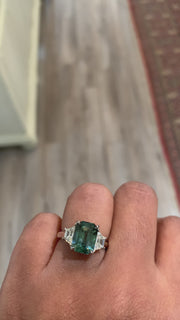 Oran emerald cut sapphire engagement ring on Rad's hand. DANA WALDEN BRIDAL.