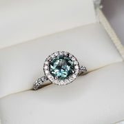 Blue-green sapphire engagement ring with white diamond halo- unique wedding jewelry by Dana Walden