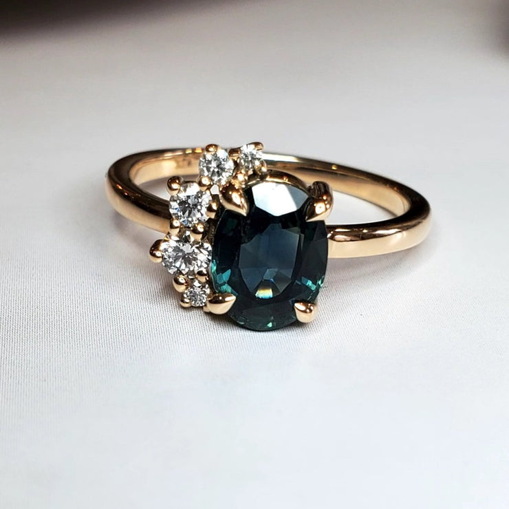 teal sapphire engagement ring with diamond demi halo by Dana Walden Bridal.