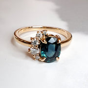 teal sapphire engagement ring with diamond demi halo by Dana Walden Bridal.
