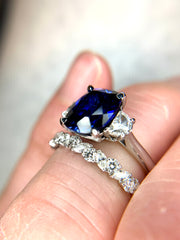 Side view on the finger of the Alexandra 4 Carat Sapphire Engagement Ring with Half Moon accent diamonds - 3 stone - paired with Diamond Wreath Wedding Band
