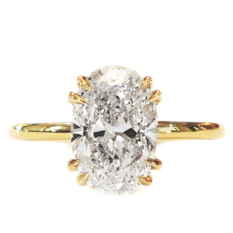 Oval lab diamond solitaire engagement ring set in yellow gold. Dana Walden NYC