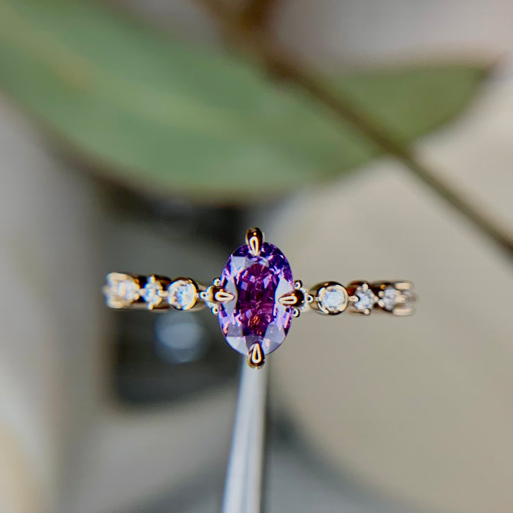 Purple sapphire engagement ring with thin diamond band and NSEW compass prongs in Yellow Gold by Dana Walden Bridal in NYC