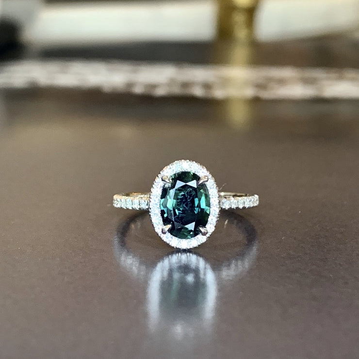 Teal sapphire with diamond halo and diamond micro pave set in white gold. DANA WALDEN BRIDAL. 