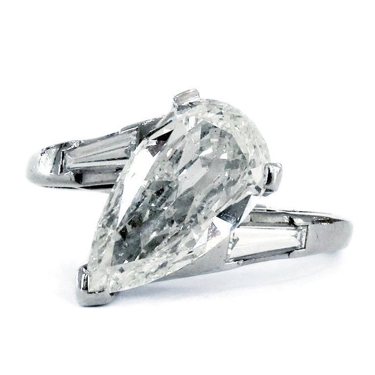 Modern engagement ring with pear-shaped diamond and baguette diamonds. Made by Dana Walden Bridal NYC.