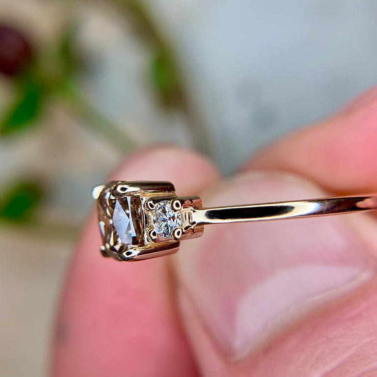 1 carat cushion diamond three stone engagement ring in yellow gold with white diamond accents by Dana Walden Bridal NYC, side profile