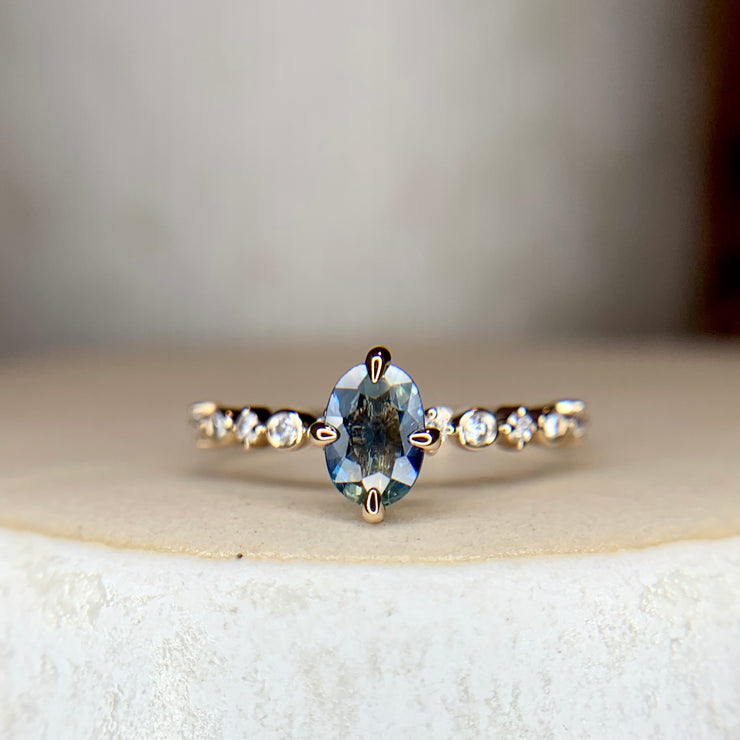 Blue green bicolor sapphire engagement ring with teal hues in yellow gold & diamond band & NSEW prongs by Dana Walden Bridal NYC