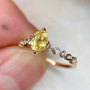 Oval yellow sapphire engagement ring with deco inspired yellow gold band and diamond accents by Dana Walden Bridal NYC