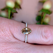 1.1ct Oval champagne diamond ring with thin micro-pave diamond band on hand in rose gold by Dana Walden Bridal NYC