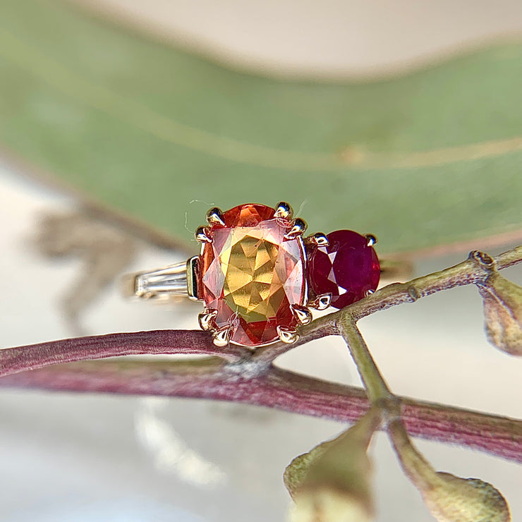 Orange sapphire cluster engagement ring with ruby and diamond baguette in yellow gold by Dana Walden Bridal NYC