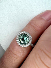 Shown On the Hand Elsa 1.71ct Blue-Green Sapphire Engagement Ring with White Diamond Halo