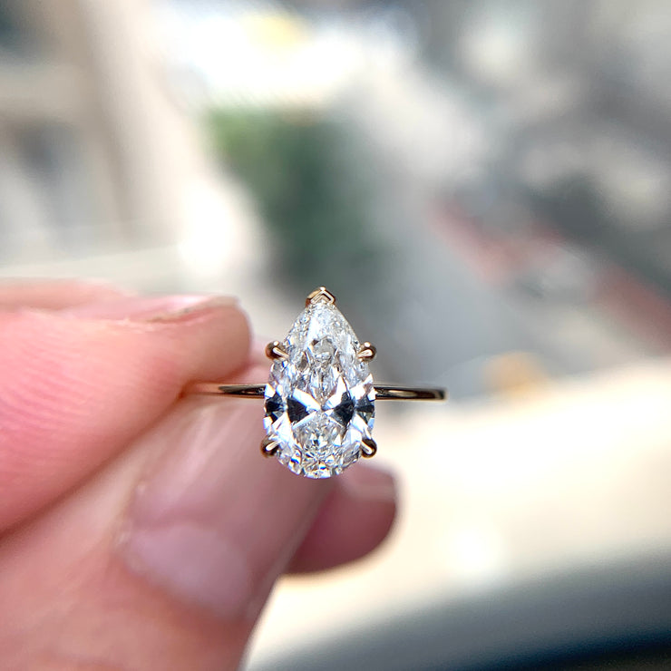 1.5 carat pear-shaped lab created diamond engagement ring set in yellow gold. DANA WALDEN BRIDAL.