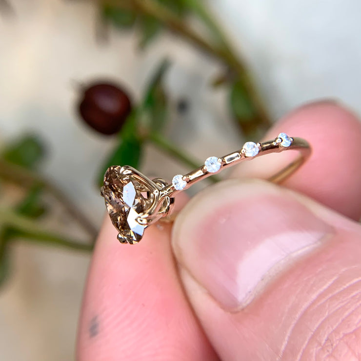 1.13 carat champagne oval cut diamond in yellow gold with thin diamond band by Dana Walden Bridal NYC