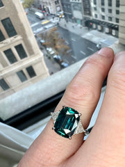 Natural Teal 5.11 Carat Sapphire 3 Stone Engagement Ring In Platinum Shown On Hand Over 5th Avenue NYC - Dana Walden Showroom