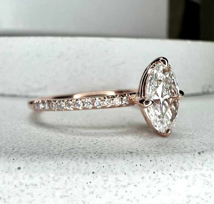 Side profile of Milly 1.01 carat lab grown diamond engagement ring with thin diamond micro-pavé band and low set diamond in sustainable 14k rose gold with compass NSEW claw prongs