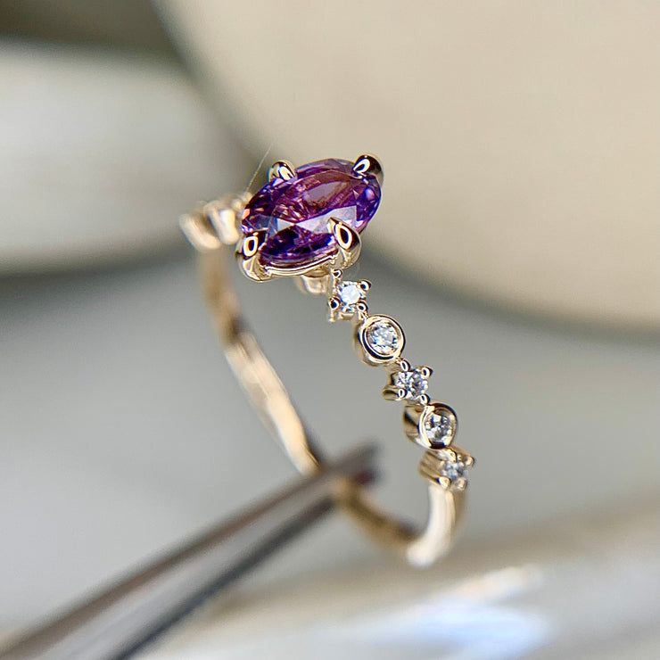 Unique purple sapphire engagement ring with delicate diamond band in yellow gold by Dana Walden Bridal, NYC